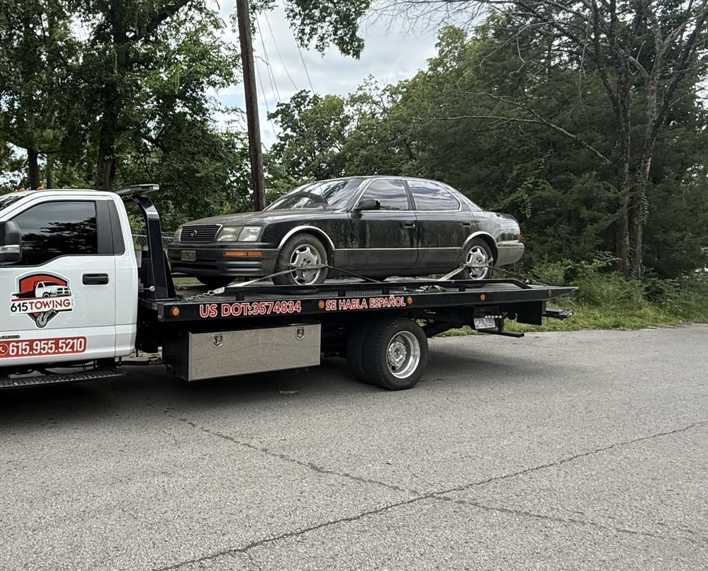 615 Towing flatbed transporting a vehicle